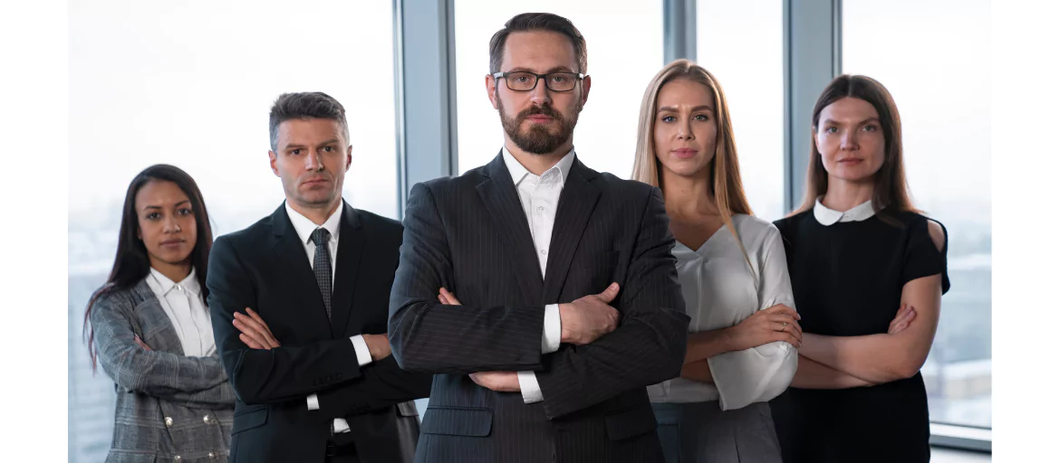individuals standing with folded hands wearing formals
